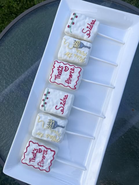 Personalized rice krispie pops on a white platter