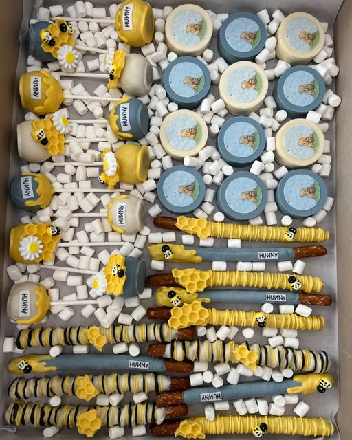 Winnie the Pooh baby shower set with honey pot cake pops, pretzel rods and Oreos